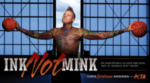 Basketball player, shirtless, heavily tattooed, has arms spread out, head faced up, holding a basketball in each hand