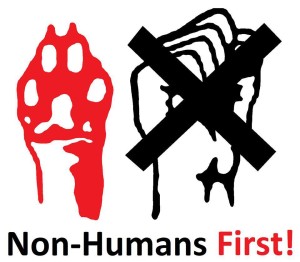 Reads "Non-Humans First!" Image of upraised dog paw and human fist, with human fist crossed out