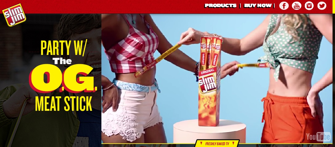 Image from Slim Jim website that shows 2 white women's bodies in tiny shorts and tops with midriffs exposed. They are touching each other with the beef jerky sticks.