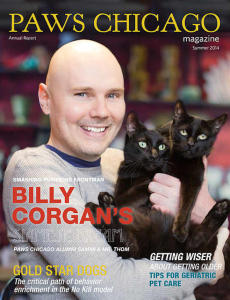 Corgan poses on the cover of PAWS with two black cats