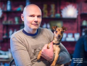Corgan posing with dog for PAWS magazine