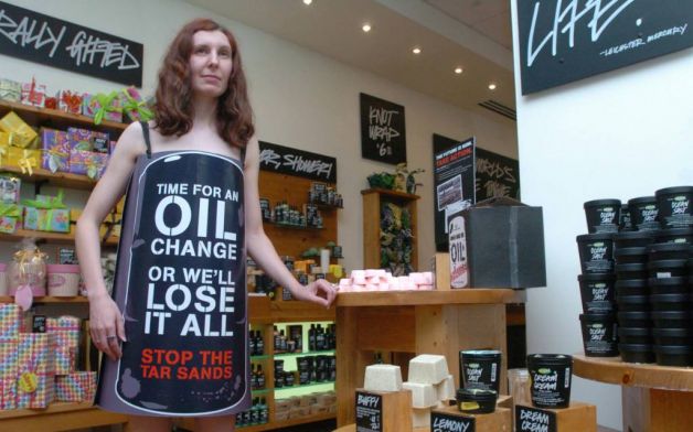 White woman wearing barrel sign, nude underneath in LUSH store