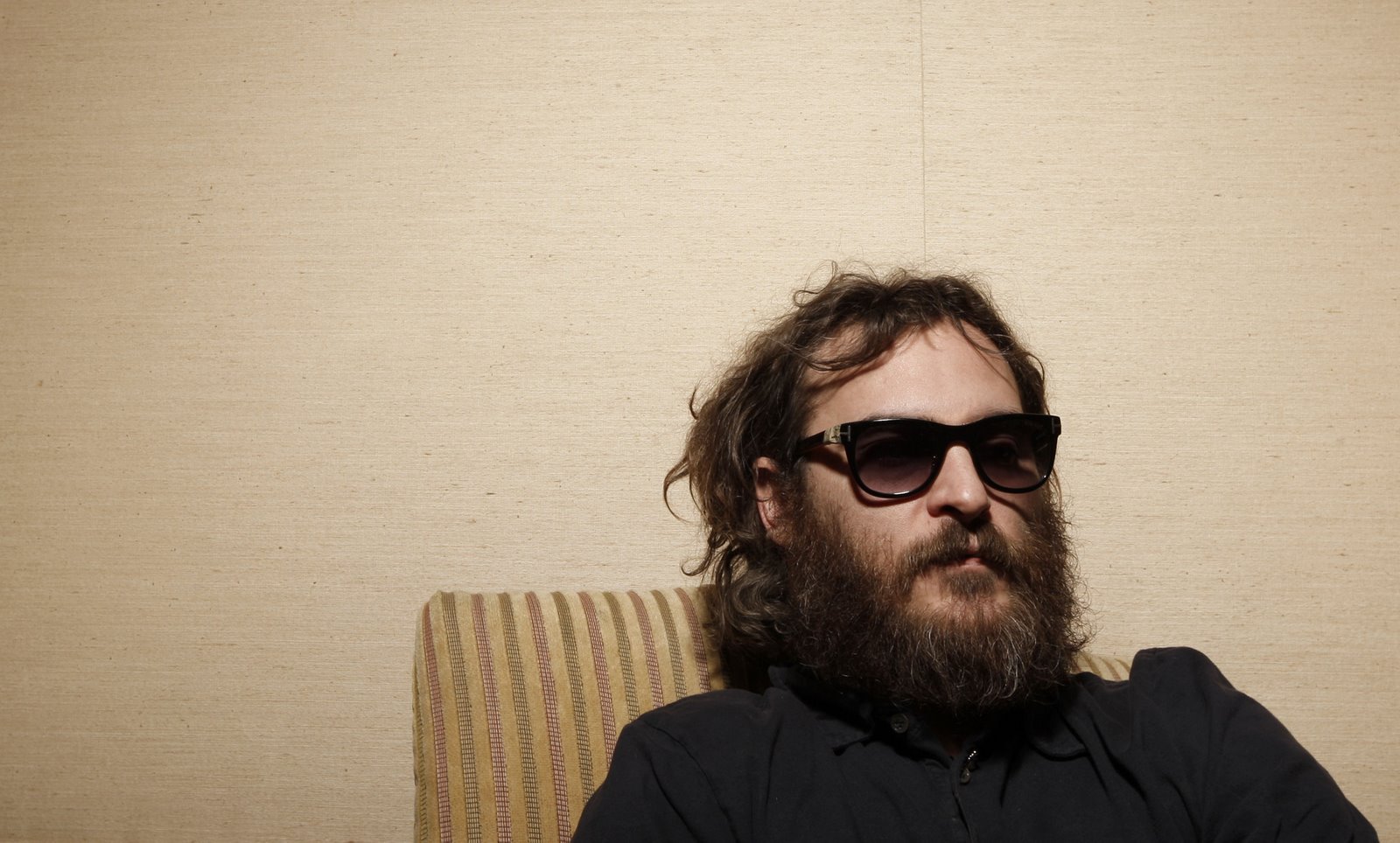 Actor Joaquin Phoenix poses for a portrait in Beverly Hills. He has a huge beard and is looking very scruffy.